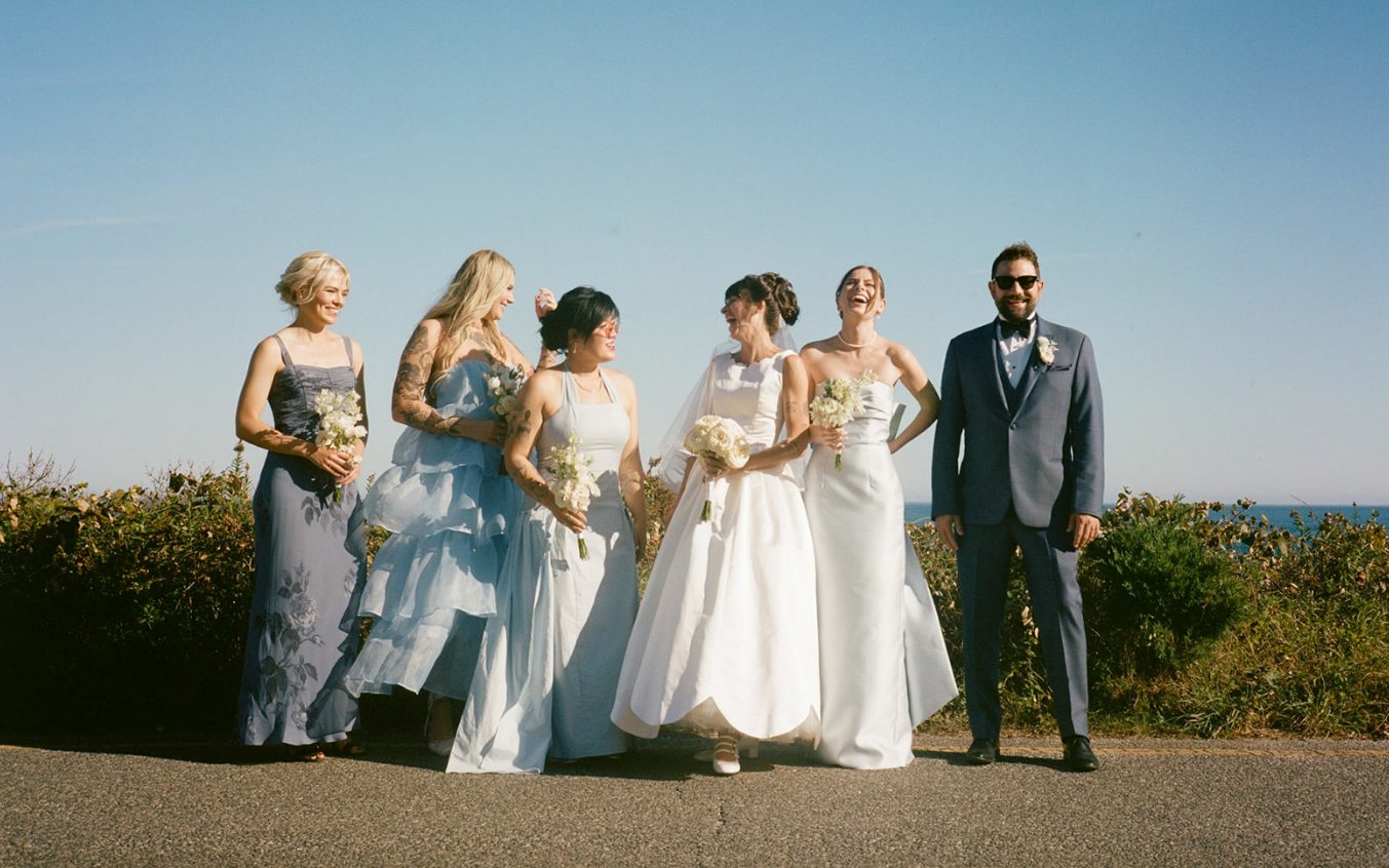 Bridal party group photo by the sea