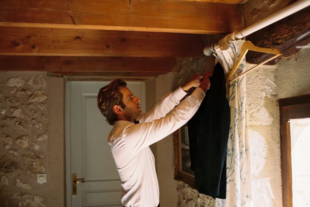 Groom hanging his jacket before the ceremony