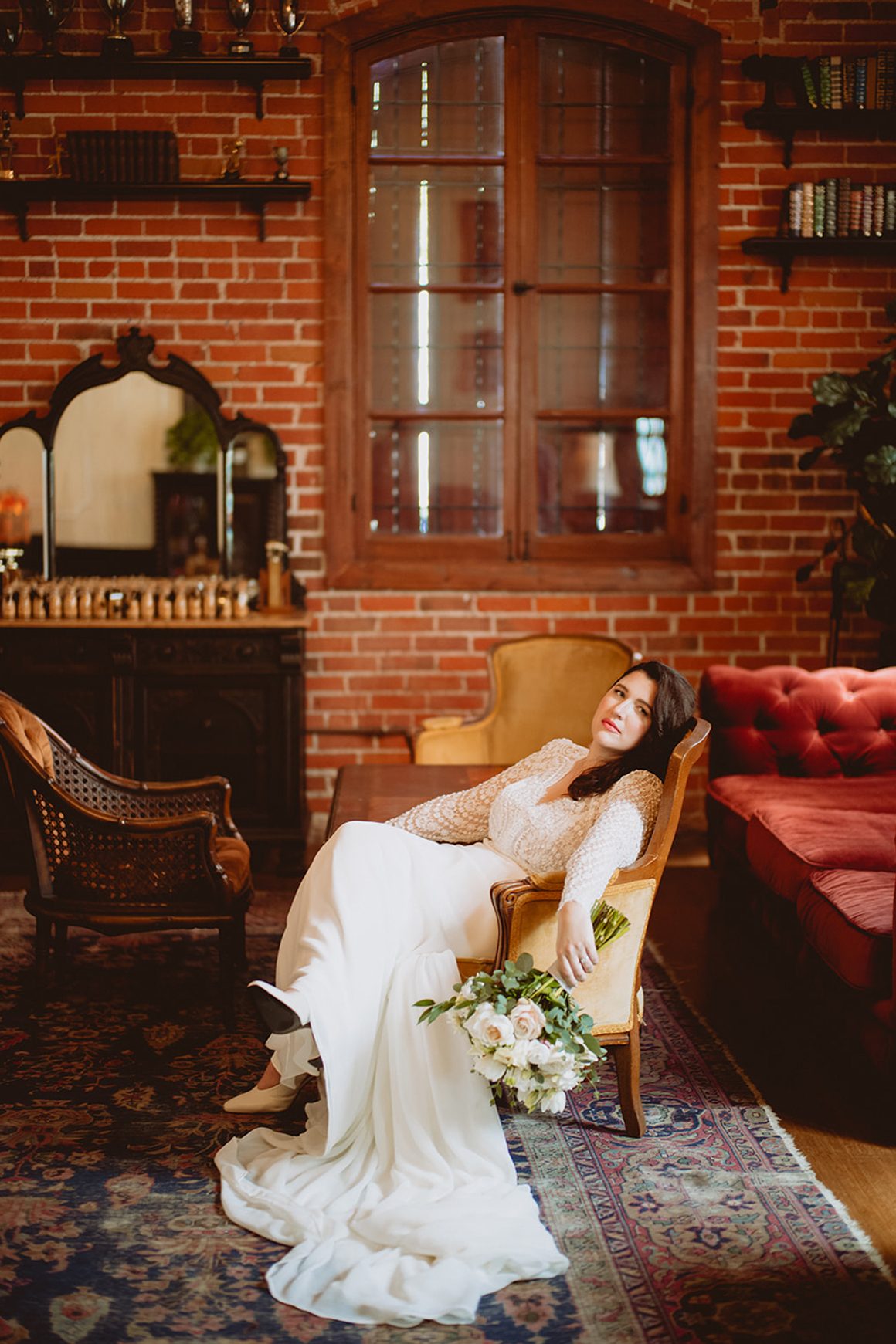 Bride seated in a vintage armchair